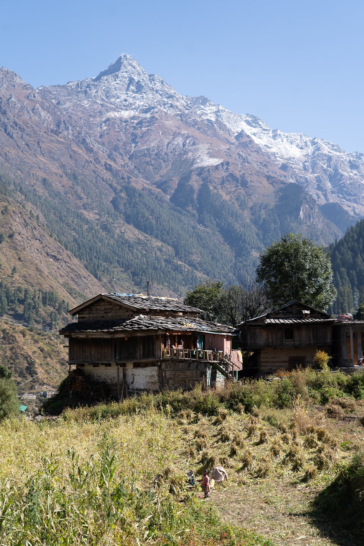 Village Below the Peak: A mountain village below a snow-covered peak. Canvas print by Ori Ganz.